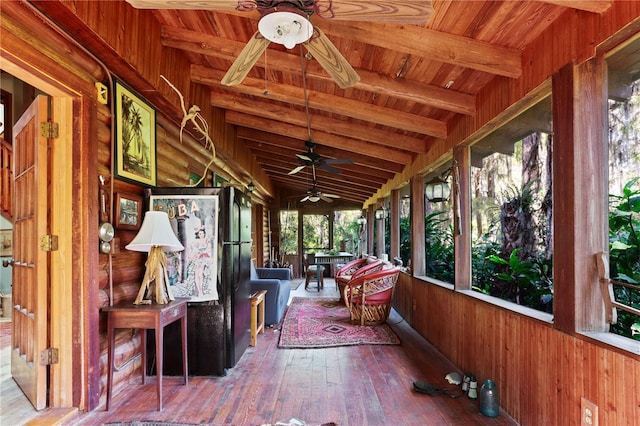 unfurnished sunroom featuring vaulted ceiling with beams and wooden ceiling