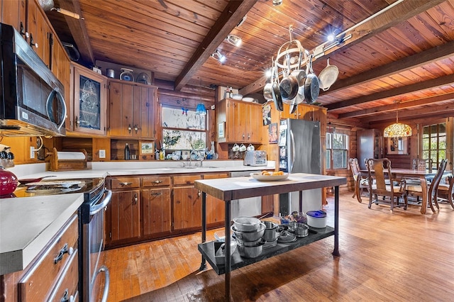 kitchen featuring beamed ceiling, light hardwood / wood-style flooring, stainless steel appliances, and wooden ceiling