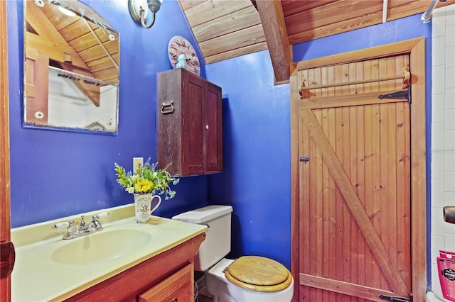 bathroom with wood walls, wood ceiling, toilet, vaulted ceiling, and vanity