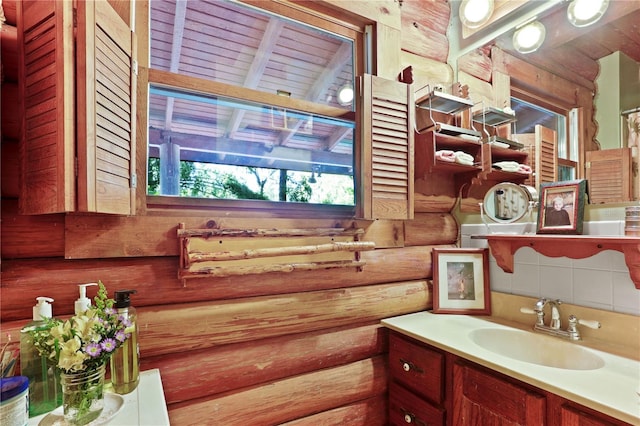 bathroom with vanity and rustic walls