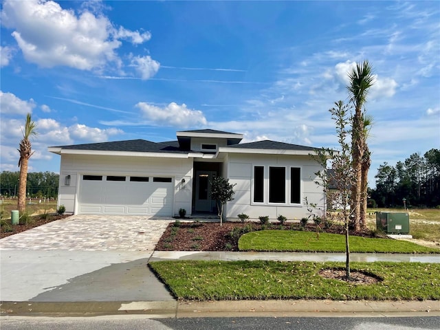 view of front facade with a front lawn and a garage