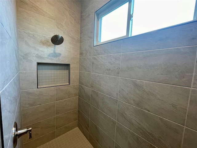 bathroom with tiled shower