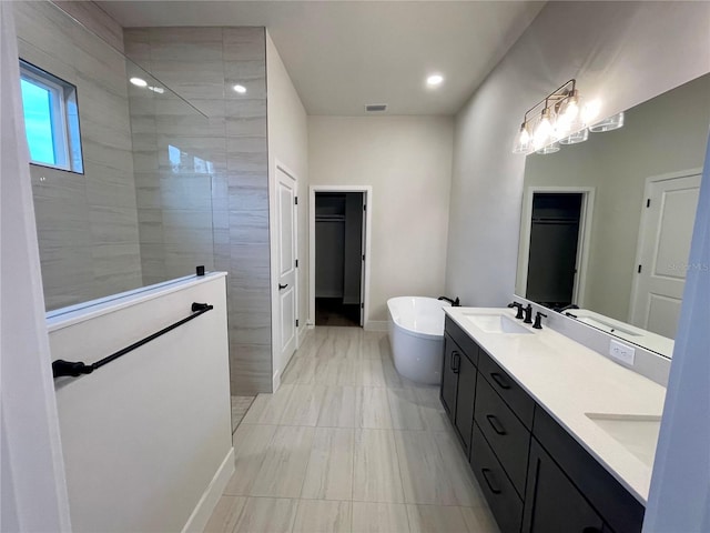 840 SW 144th Dr, Newberry, FL 32669 - bathroom featuring double vanity, a walk in shower, a soaking tub, baseboards, and recessed lighting
