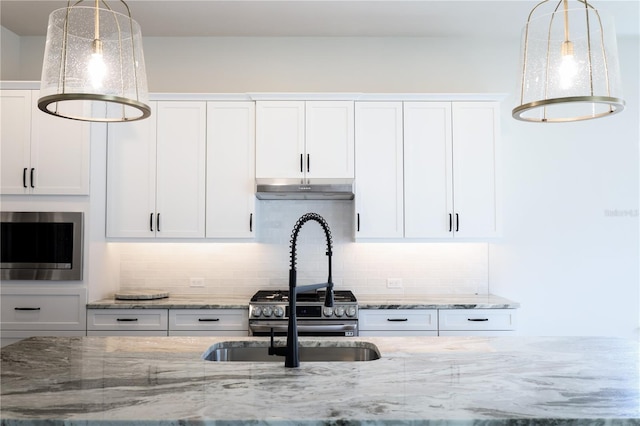 840 SW 144th Dr, Newberry, FL 32669 - kitchen with stainless steel microwave, white cabinets, and tasteful backsplash