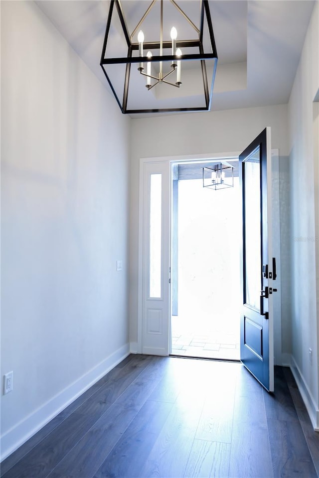 840 SW 144th Dr, Newberry, FL 32669 - entrance foyer with a chandelier, dark wood-style flooring, and baseboards