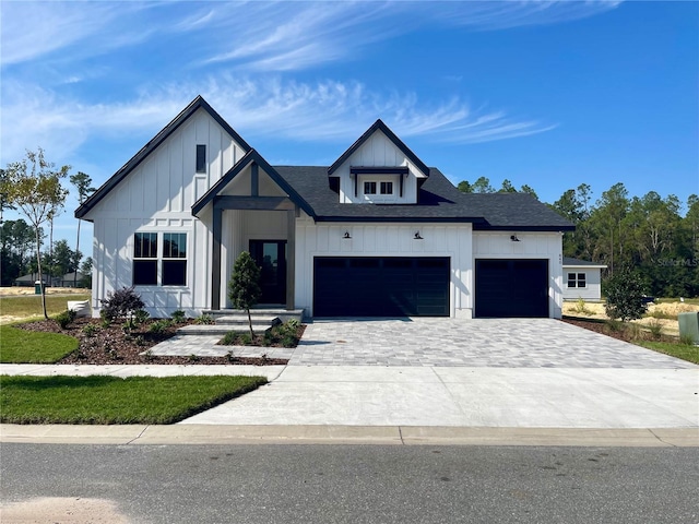 840 SW 144th Dr, Newberry, FL 32669 - modern farmhouse style home with board and batten siding, a garage, decorative driveway, and a shingled roof