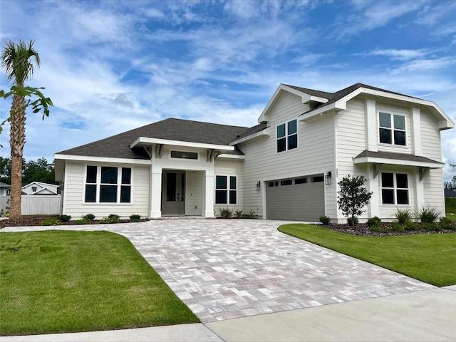 view of front facade featuring a front lawn and a garage