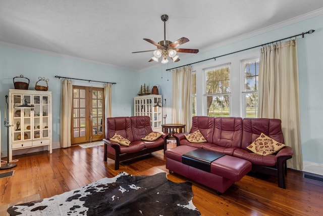 living room featuring ornamental molding, wood-type flooring, a healthy amount of sunlight, and ceiling fan