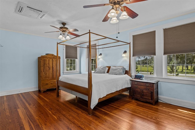 bedroom with ceiling fan, hardwood / wood-style flooring, multiple windows, and crown molding