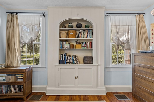 sitting room featuring hardwood / wood-style floors, a textured ceiling, and a healthy amount of sunlight