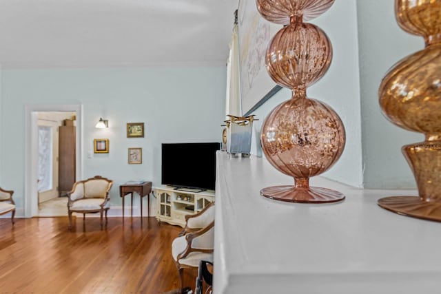 dining area with hardwood / wood-style flooring and ornamental molding