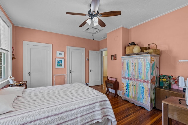 bedroom with dark wood-type flooring, ceiling fan, crown molding, and a textured ceiling