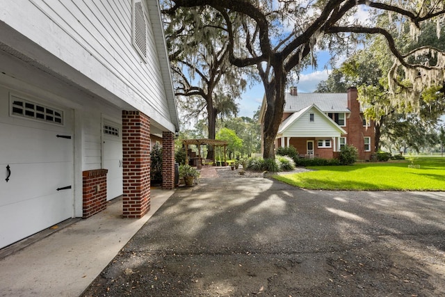 view of property exterior featuring a yard and a garage