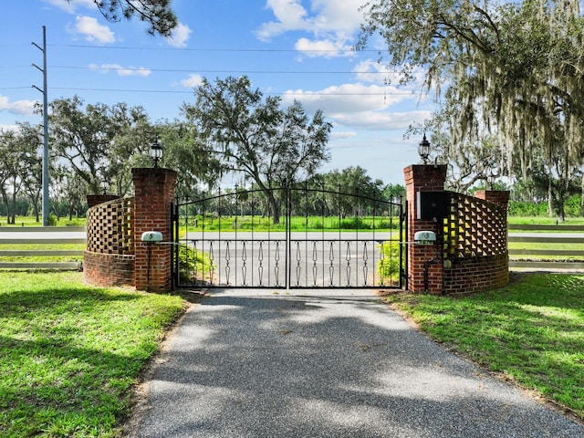 view of gate featuring a yard