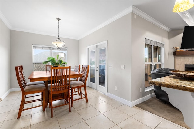 dining area with french doors, ornamental molding, a tile fireplace, and light tile patterned floors