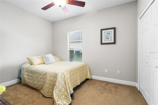 carpeted bedroom with a closet and ceiling fan