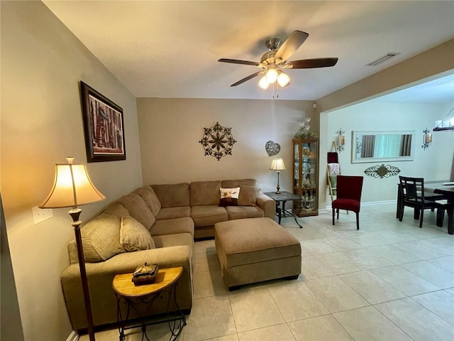 tiled living room with ceiling fan