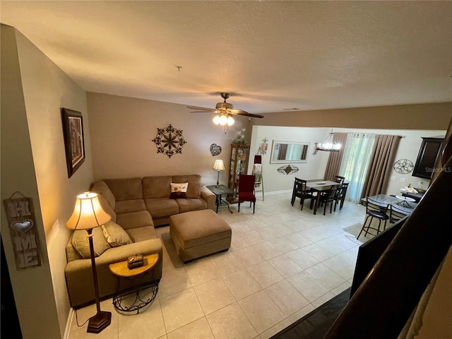 tiled living room with a textured ceiling and ceiling fan with notable chandelier