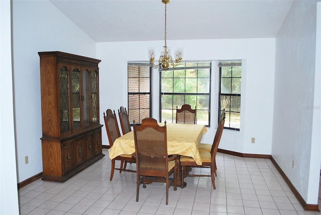 tiled dining room featuring a notable chandelier and a wealth of natural light