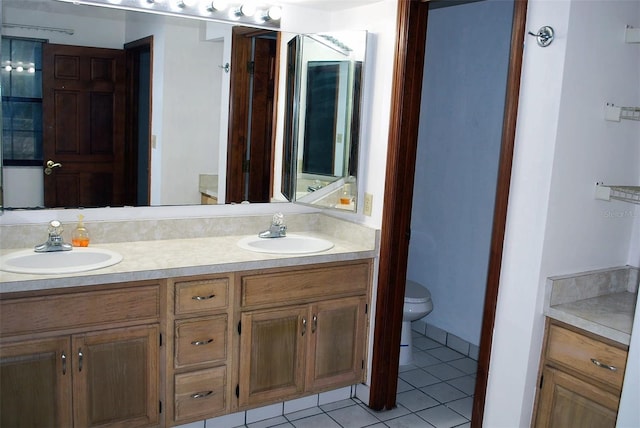 bathroom featuring tile patterned floors, vanity, and toilet