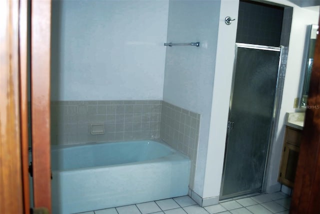 bathroom featuring tile patterned floors, vanity, and shower with separate bathtub