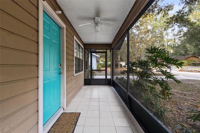 unfurnished sunroom with ceiling fan