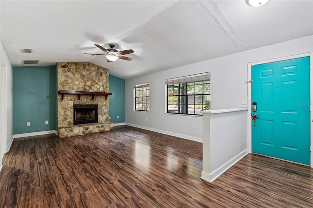 foyer entrance with dark hardwood / wood-style flooring, ceiling fan, a fireplace, and vaulted ceiling