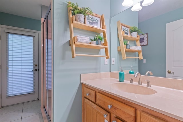 bathroom featuring walk in shower, vanity, and tile patterned floors