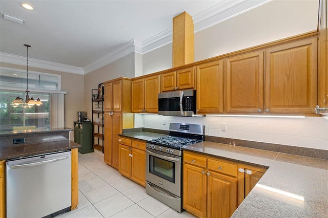 6225 NW 105th Ave, Alachua, FL 32615 - kitchen featuring stainless steel appliances, ornamental molding, dark stone countertops, light tile patterned floors, and decorative light fixtures