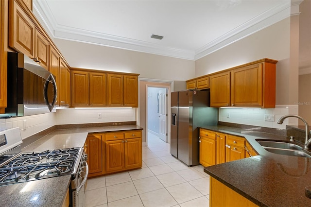 kitchen featuring stainless steel appliances, sink, light tile patterned floors, crown molding, and backsplash