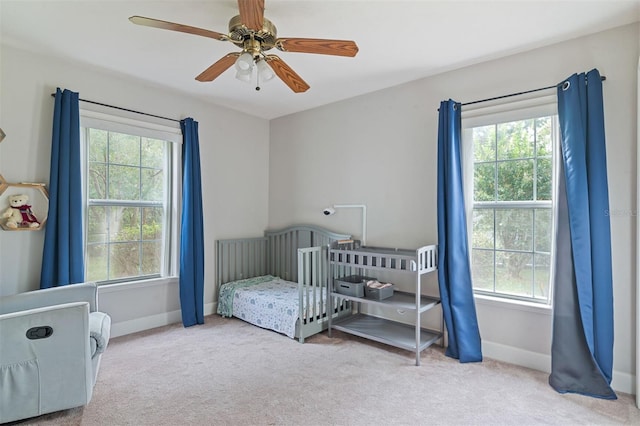 6225 NW 105th Ave, Alachua, FL 32615 - carpeted bedroom with multiple windows, baseboards, and a ceiling fan