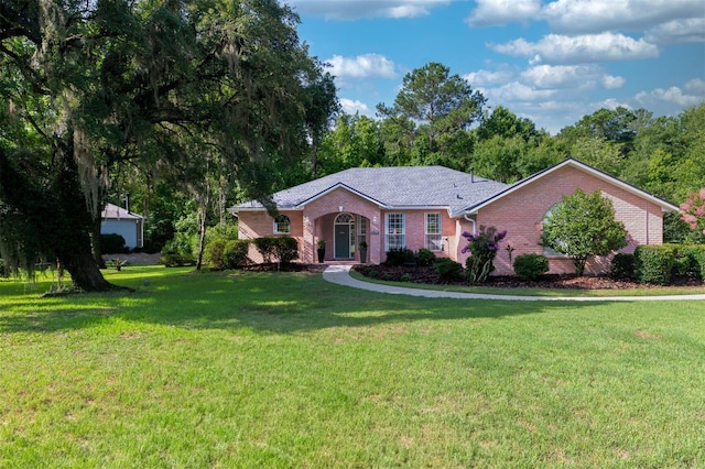 6225 NW 105th Ave, Alachua, FL 32615 - ranch-style house with brick siding and a front yard