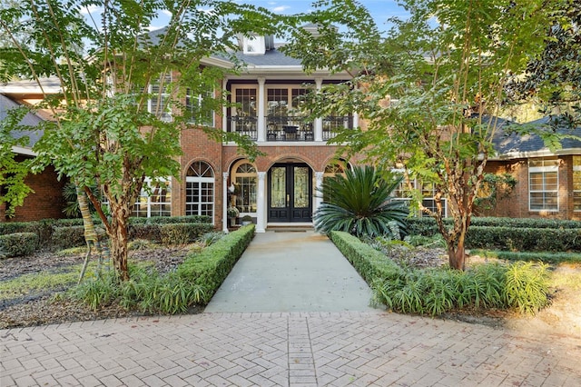 view of front of property with french doors and a balcony