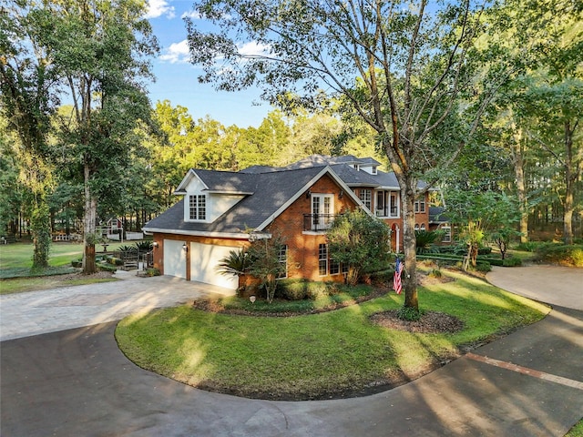 view of front facade with a front yard and a garage