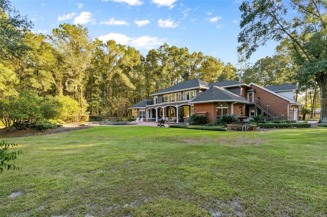 back of property featuring a lawn