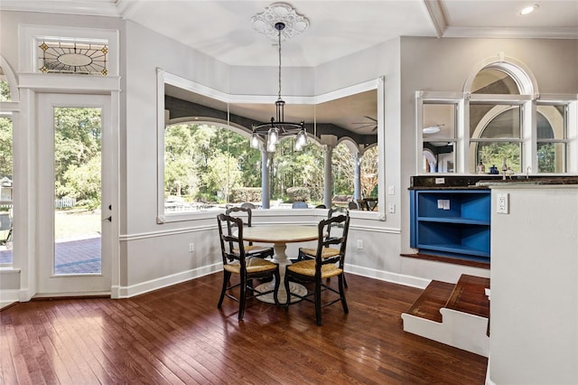 dining room featuring ornamental molding, plenty of natural light, and dark hardwood / wood-style flooring