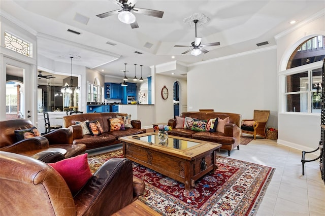 tiled living room featuring ornamental molding and ceiling fan