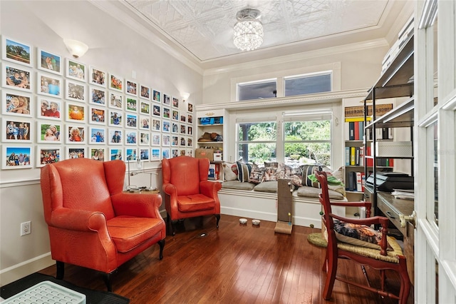 sitting room with crown molding and hardwood / wood-style floors