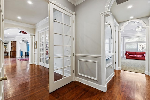 hallway featuring decorative columns, french doors, ornamental molding, and dark hardwood / wood-style flooring