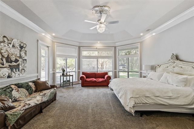 bedroom with ornamental molding, carpet floors, a raised ceiling, and ceiling fan