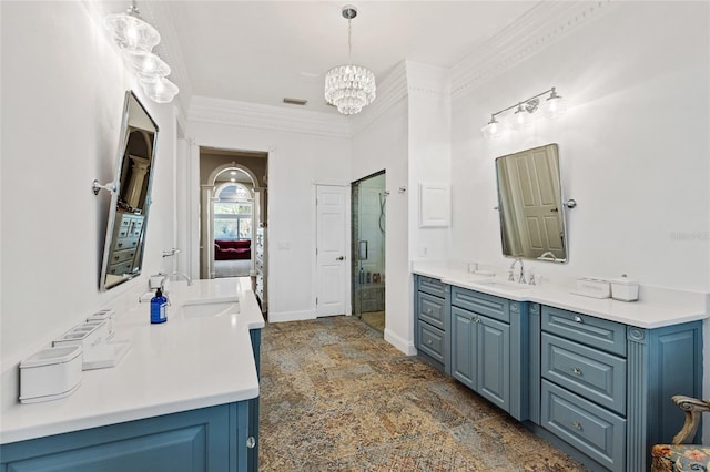 bathroom featuring vanity, ornamental molding, a chandelier, and a shower with door