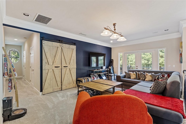 carpeted living room with crown molding, a barn door, and french doors