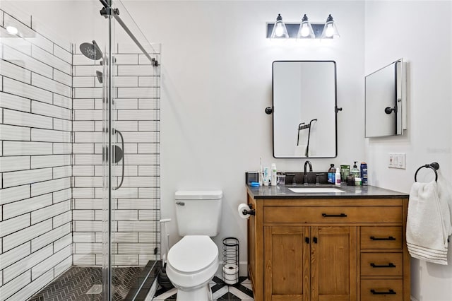 bathroom featuring vanity, toilet, and an enclosed shower