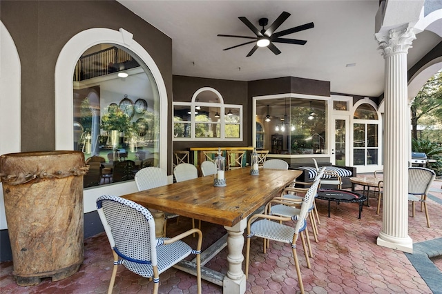 dining area with ornate columns and ceiling fan