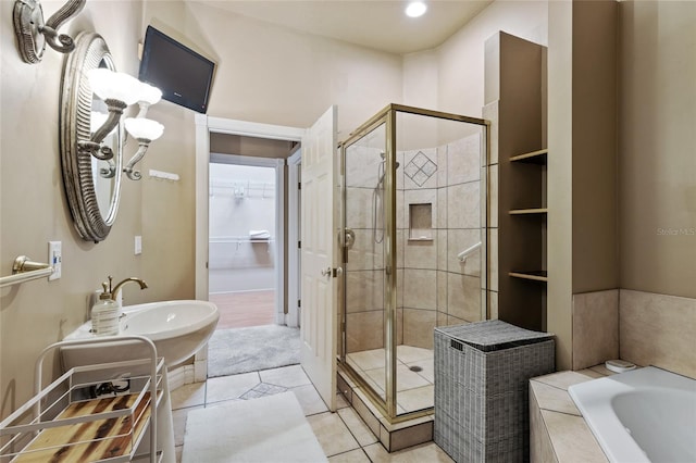 bathroom with tile patterned floors and shower with separate bathtub