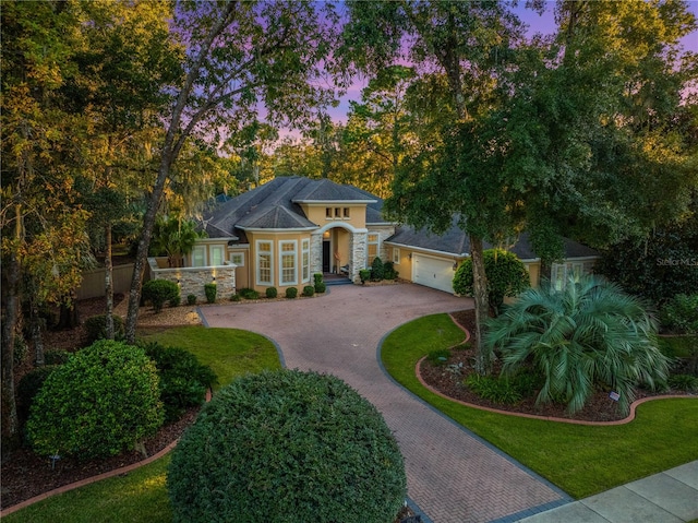 view of front of house featuring a yard and a garage