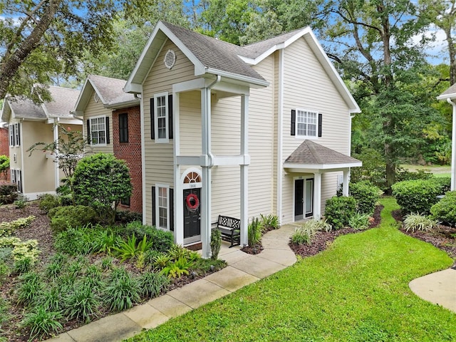 10000 SW 52nd Ave Unit 164, Gainesville, FL 32608 - view of front of home with a shingled roof and a front yard