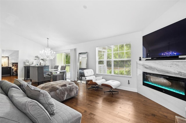 10000 SW 52nd Ave Unit 164, Gainesville, FL 32608 - living area with lofted ceiling, a chandelier, plenty of natural light, a premium fireplace, and wood finished floors