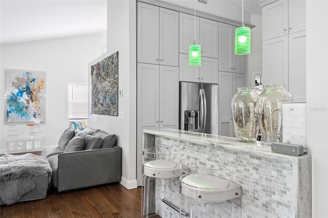 10000 SW 52nd Ave Unit 164, Gainesville, FL 32608 - kitchen with stainless steel refrigerator with ice dispenser, dark wood-style floors, open floor plan, pendant lighting, and light stone countertops