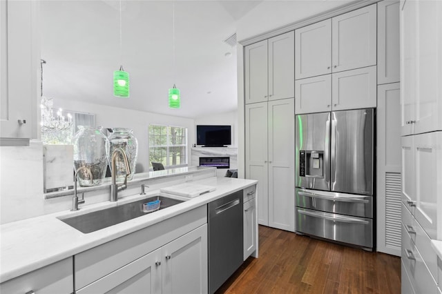 10000 SW 52nd Ave Unit 164, Gainesville, FL 32608 - kitchen featuring stainless steel appliances, light countertops, dark wood-style flooring, and a chandelier